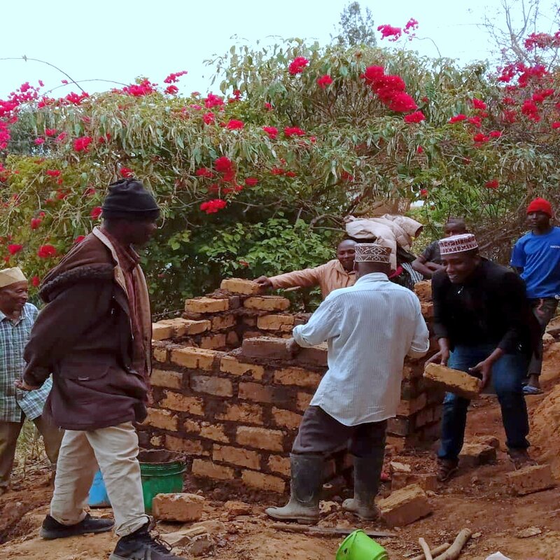 Our technicians constructing a toilet for a family.