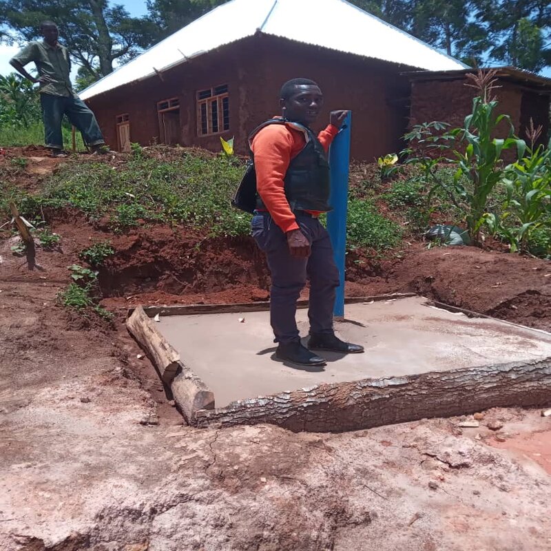 Mr. Hussein at one of the finished toilet chambers.